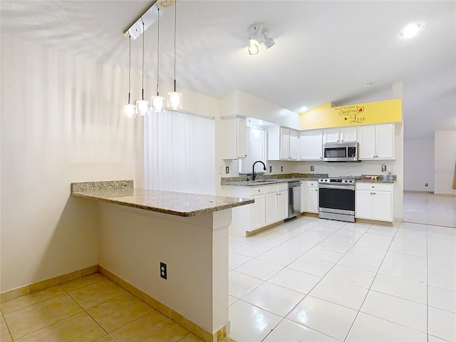 kitchen with pendant lighting, kitchen peninsula, white cabinets, and appliances with stainless steel finishes