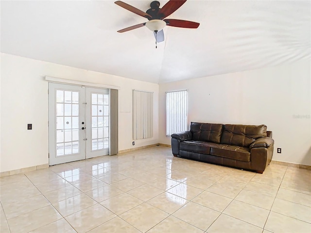 living room with vaulted ceiling, french doors, and light tile patterned flooring