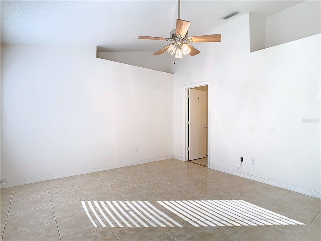 tiled empty room featuring high vaulted ceiling and ceiling fan