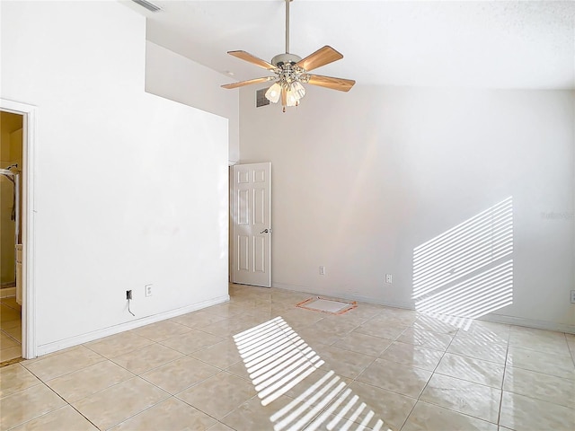 spare room featuring high vaulted ceiling, ceiling fan, and light tile patterned flooring