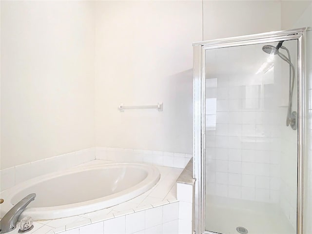 bathroom featuring separate shower and tub