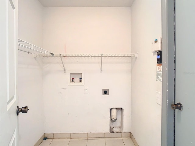 washroom featuring electric dryer hookup, washer hookup, and light tile patterned flooring