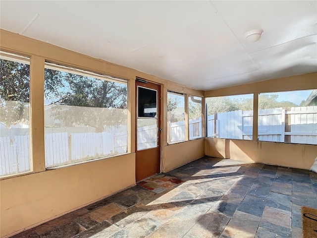 unfurnished sunroom featuring plenty of natural light