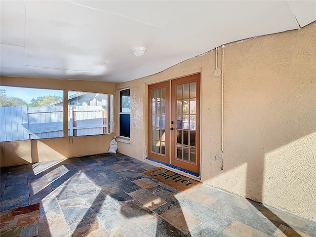 sunroom / solarium featuring french doors