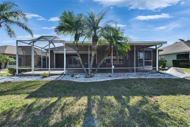 exterior space with glass enclosure and a lawn