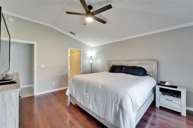 bedroom with dark hardwood / wood-style flooring, crown molding, vaulted ceiling, and a textured ceiling