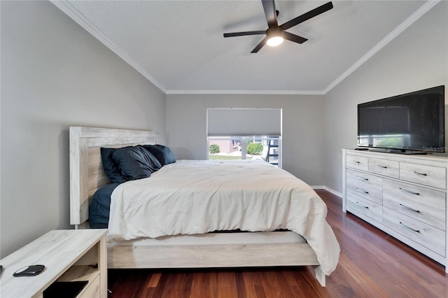 bedroom with dark wood-type flooring, vaulted ceiling, ornamental molding, and ceiling fan