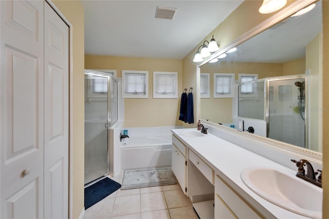 bathroom featuring tile patterned flooring, vanity, and separate shower and tub