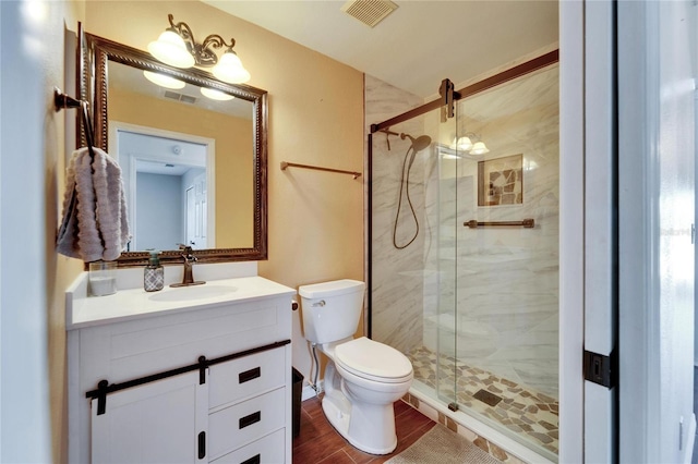 bathroom featuring walk in shower, vanity, toilet, and hardwood / wood-style flooring