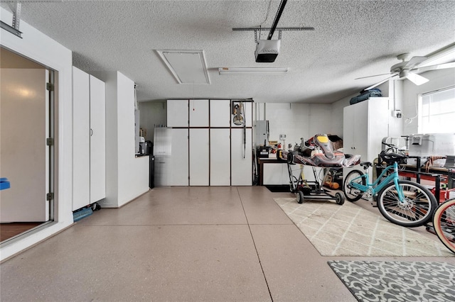 garage with ceiling fan and a garage door opener