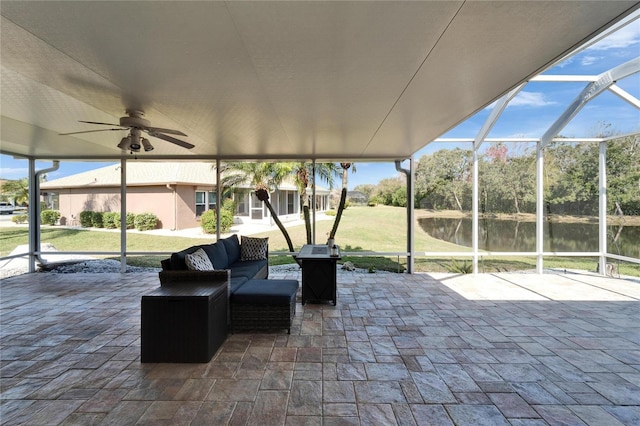 view of patio / terrace with a water view, an outdoor hangout area, ceiling fan, and a lanai