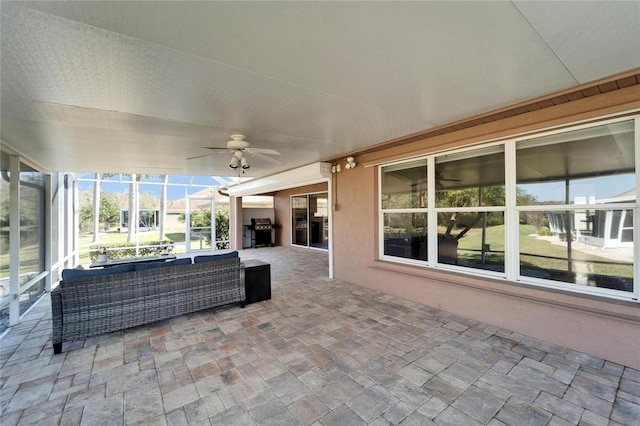 view of patio with ceiling fan, a grill, outdoor lounge area, and a lanai