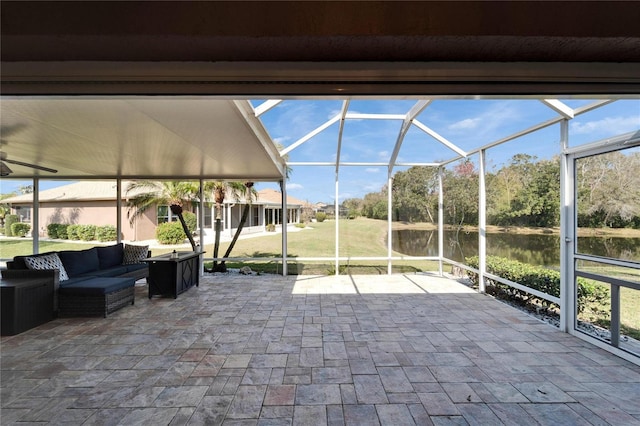 view of patio with a water view, outdoor lounge area, and a lanai