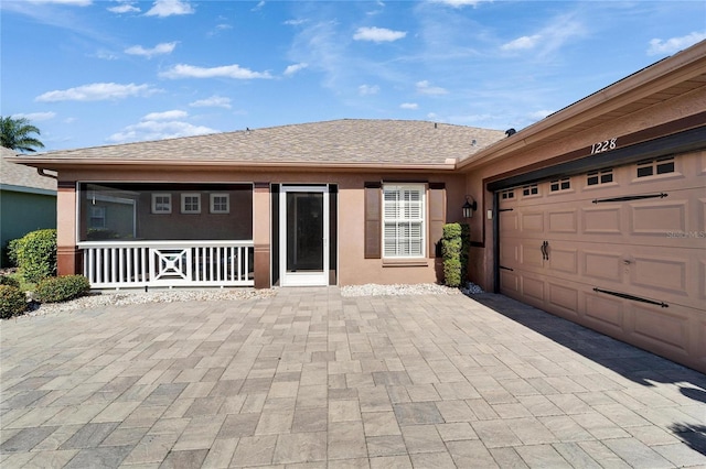 view of front of house featuring a garage and covered porch