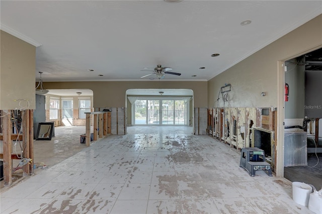 unfurnished living room featuring crown molding and ceiling fan