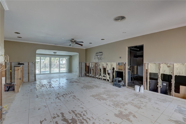 unfurnished living room featuring ceiling fan and ornamental molding