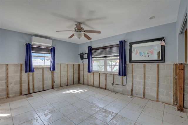 empty room with a healthy amount of sunlight, ceiling fan, and a wall mounted AC