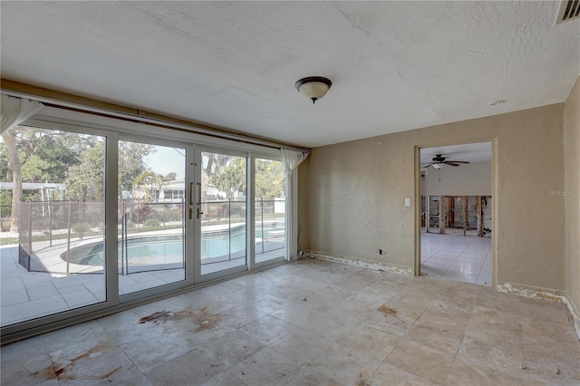 unfurnished room featuring a textured ceiling