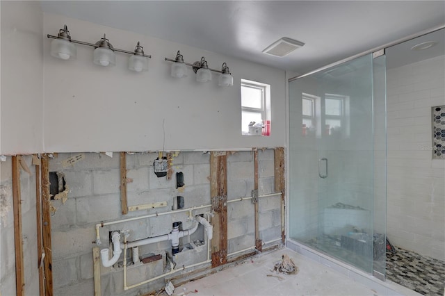 bathroom featuring a shower with shower door