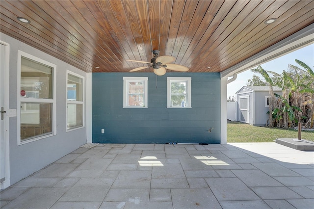 view of patio / terrace with ceiling fan and a storage shed