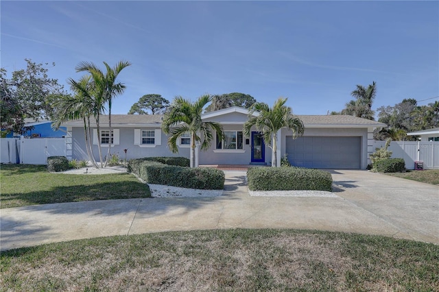 single story home featuring a garage and a front lawn