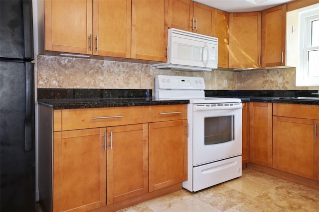 kitchen featuring dark stone counters, white appliances, brown cabinetry, and decorative backsplash