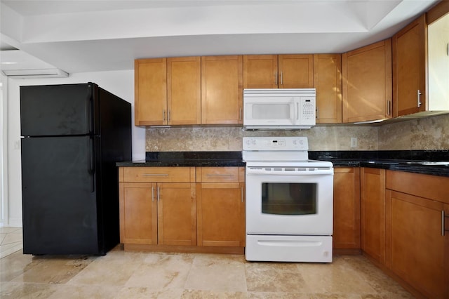 kitchen with dark stone counters, white appliances, backsplash, and brown cabinets