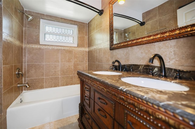 bathroom with washtub / shower combination, tile walls, backsplash, and a sink