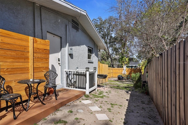 view of property exterior with a fenced backyard and stucco siding