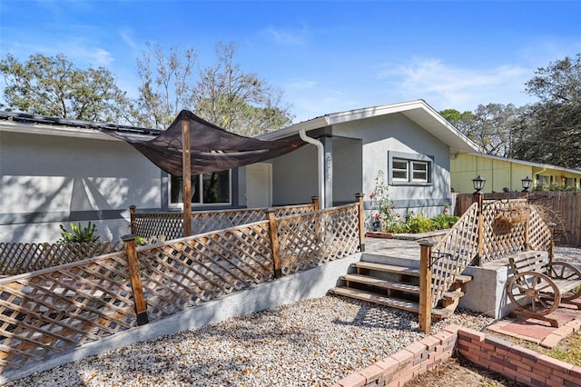 exterior space featuring fence and stucco siding