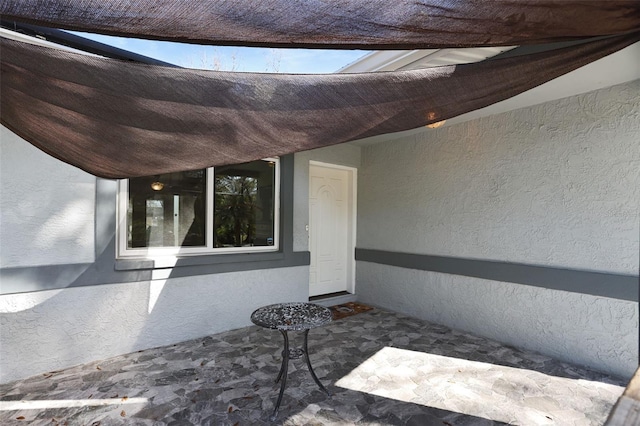 doorway to property featuring stucco siding