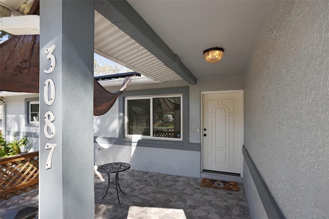 property entrance featuring stucco siding