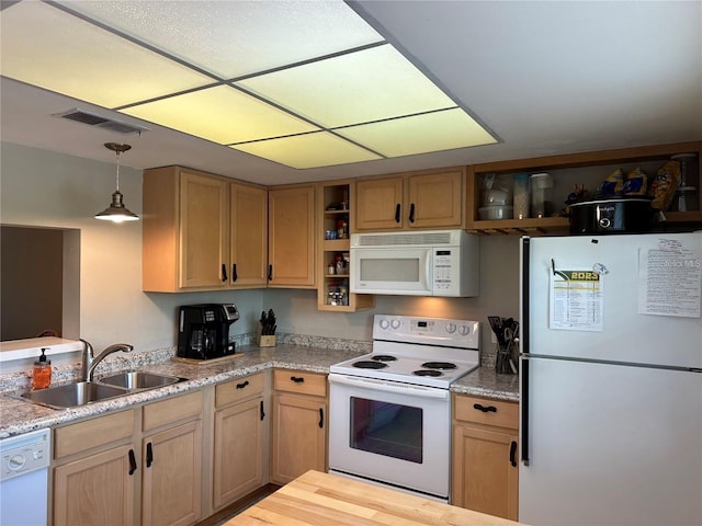 kitchen with sink, white appliances, decorative light fixtures, and light brown cabinets