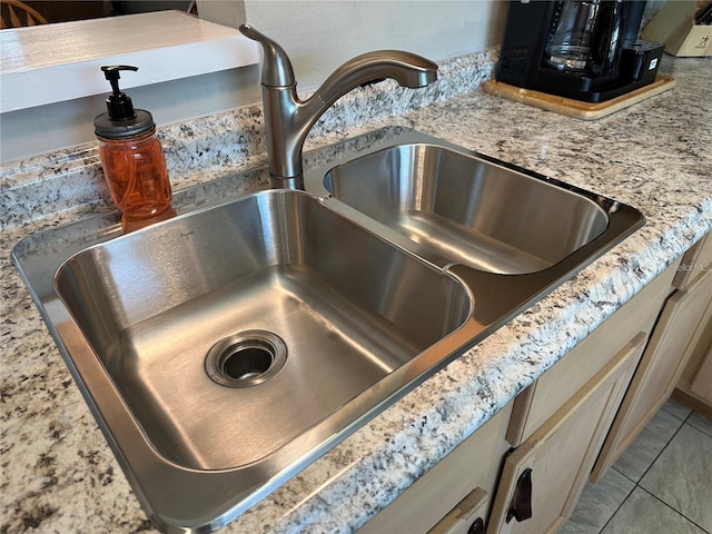 room details featuring sink, light stone countertops, and light brown cabinets