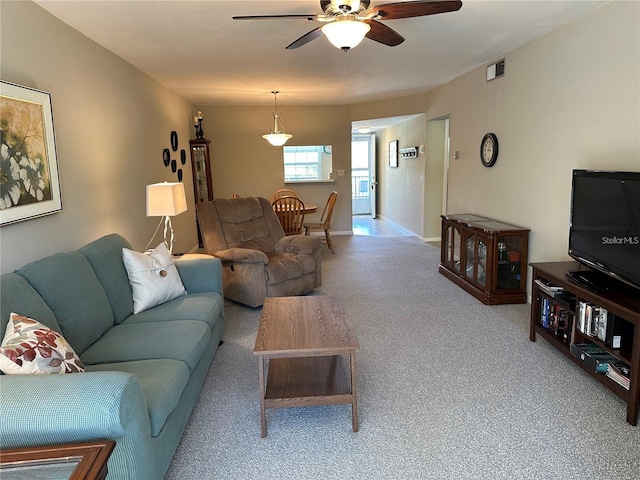 carpeted living room with ceiling fan