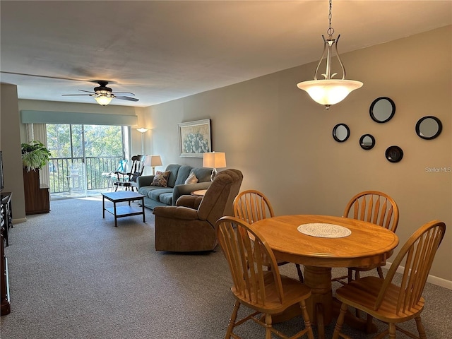 carpeted dining space featuring ceiling fan