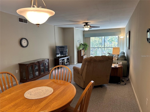 dining area featuring light carpet and ceiling fan