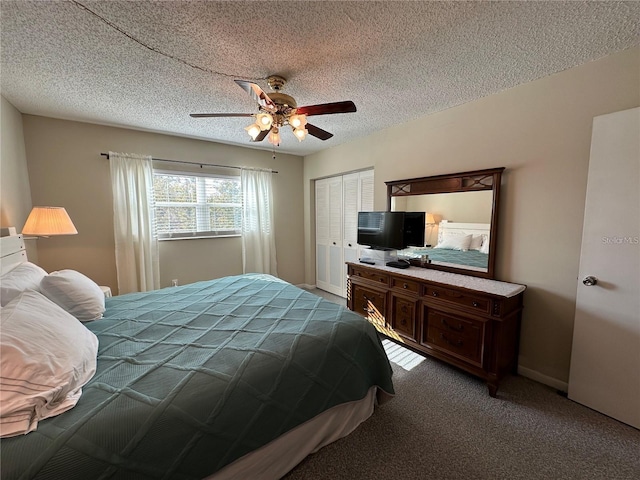 carpeted bedroom with ceiling fan, a textured ceiling, and a closet