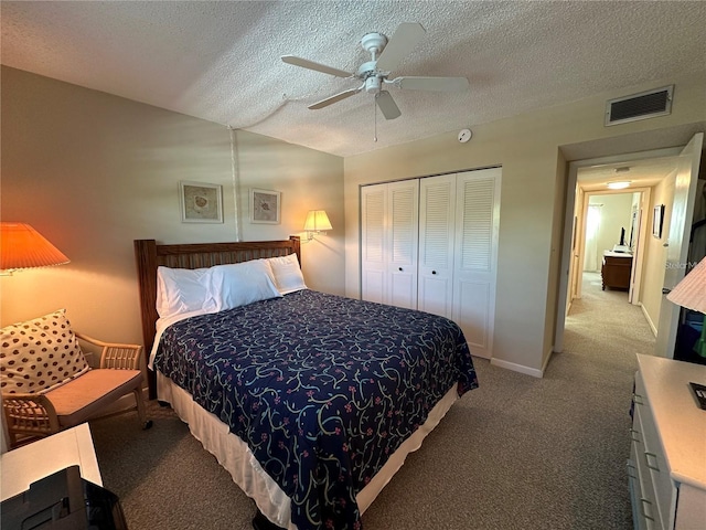 carpeted bedroom with lofted ceiling, ceiling fan, a closet, and a textured ceiling