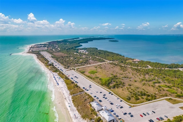 bird's eye view with a water view and a beach view