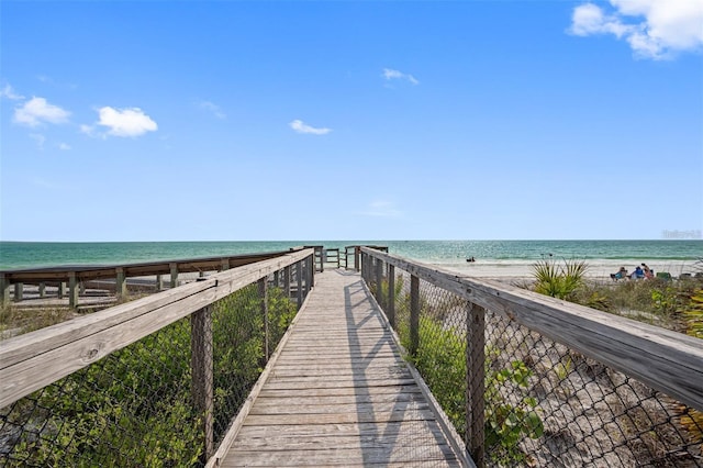 view of dock with a view of the beach and a water view