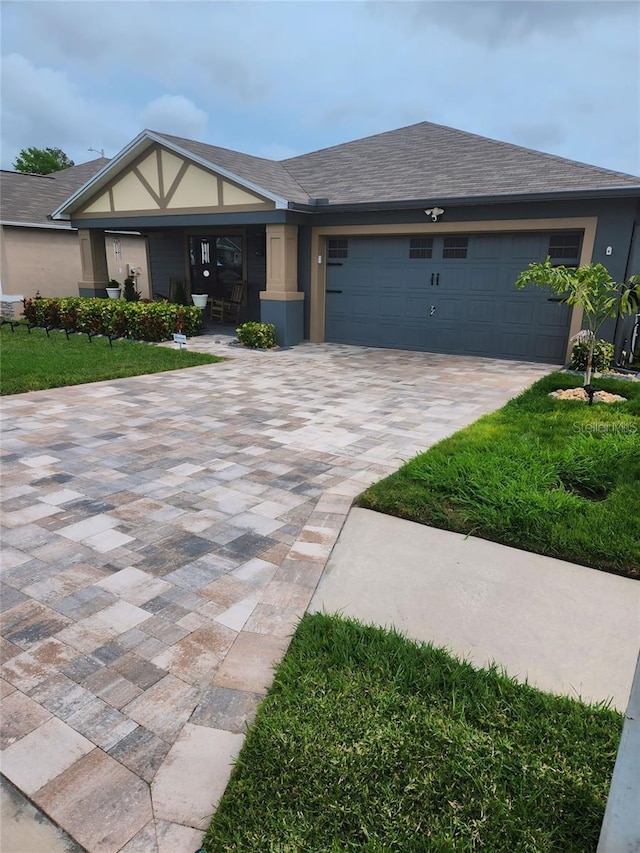 view of front of home featuring a garage and a front yard