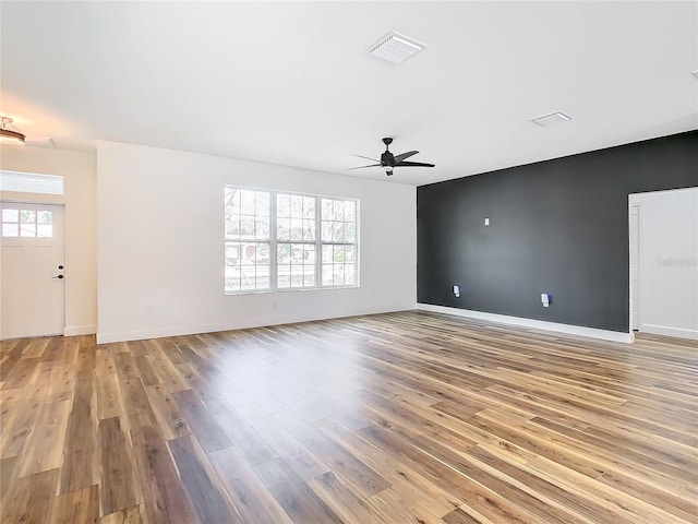 unfurnished living room featuring ceiling fan and light wood-type flooring