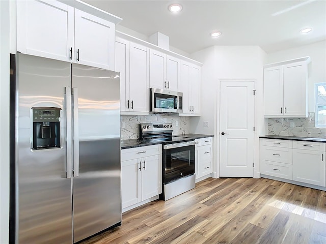 kitchen with white cabinetry, appliances with stainless steel finishes, and light hardwood / wood-style flooring