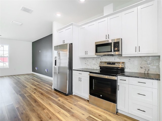 kitchen featuring decorative backsplash, stainless steel appliances, light hardwood / wood-style floors, and white cabinets