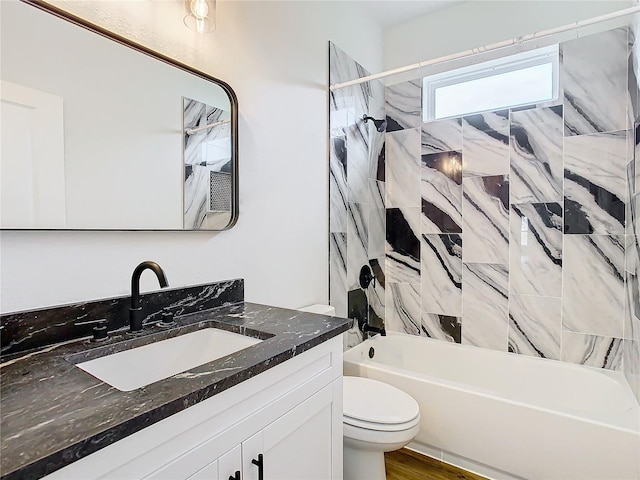 full bathroom featuring vanity, toilet, and tiled shower / bath combo