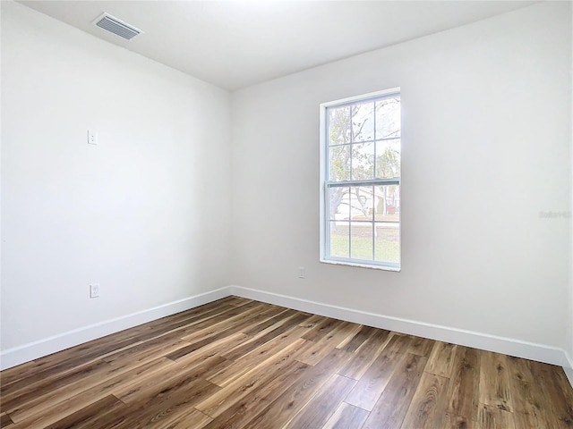 unfurnished room with hardwood / wood-style flooring