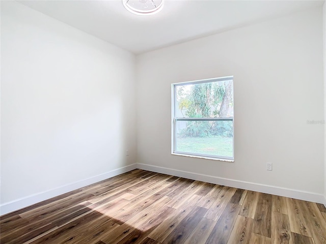 spare room with wood-type flooring