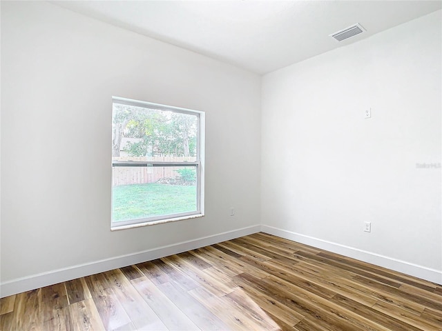 empty room with hardwood / wood-style floors