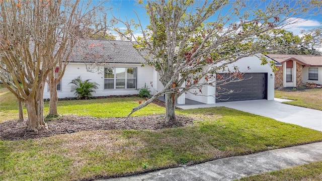 view of front of property with a garage and a front lawn